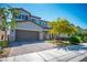Two-story house with a well-maintained lawn, a two-car garage and paved driveway at 4634 Observed St, North Las Vegas, NV 89031