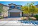 Two-story home with neutral tones, a two-car garage, and a small landscaped front yard at 4634 Observed St, North Las Vegas, NV 89031