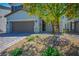 Charming two-story home with a two-car garage, decorative rock landscaping and young trees at 4634 Observed St, North Las Vegas, NV 89031