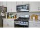 The kitchen boasts stainless steel appliances, white cabinets, and quartz countertops at 4634 Observed St, North Las Vegas, NV 89031