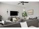 Living room offers comfortable seating, a glass coffee table, and an entertainment center with a large-screen TV at 4634 Observed St, North Las Vegas, NV 89031