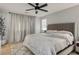 Primary bedroom with gray walls, ceiling fan and plush carpet, king size bed, neutral bedding at 4634 Observed St, North Las Vegas, NV 89031