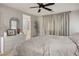 Primary bedroom features gray walls, white dresser, ceiling fan, and modern decor at 4634 Observed St, North Las Vegas, NV 89031