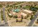 Aerial view of a community center, featuring pools, trees, tennis courts and well-manicured landscaping at 472 Via Stretto Ave, Henderson, NV 89011