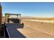 Expansive back deck area showing desert views beyond the block fence and wooden deck at 472 Via Stretto Ave, Henderson, NV 89011