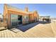 Spacious back deck with wooden floors and a view of the surrounding landscape at 472 Via Stretto Ave, Henderson, NV 89011