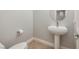 Stylish powder room featuring a pedestal sink and neutral tones offers a modern, clean design at 472 Via Stretto Ave, Henderson, NV 89011