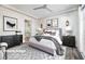 Cozy bedroom with a lilac bed, soft lighting, and stylish décor at 472 Via Stretto Ave, Henderson, NV 89011