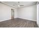 Spacious bedroom with modern ceiling fan, tray ceiling, and wood-look floors at 472 Via Stretto Ave, Henderson, NV 89011