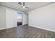 Bedroom with sliding door, wood-look floors, and modern ceiling fan at 472 Via Stretto Ave, Henderson, NV 89011