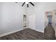 Spacious bedroom with wood-look floors, ceiling fan, and closet at 472 Via Stretto Ave, Henderson, NV 89011
