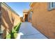 Side exterior view of the home showing the textured stucco and manicured lawn at 472 Via Stretto Ave, Henderson, NV 89011