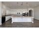 Spacious kitchen with granite countertops, stainless appliances, white cabinetry, and a large island at 472 Via Stretto Ave, Henderson, NV 89011