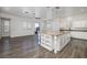 Modern kitchen with a large central island, granite countertops, and hardwood flooring at 472 Via Stretto Ave, Henderson, NV 89011