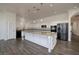 Bright kitchen with stainless steel appliances, granite countertops, and a large island at 472 Via Stretto Ave, Henderson, NV 89011