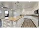 Bright kitchen with granite countertops, white cabinets, and a large island with storage at 472 Via Stretto Ave, Henderson, NV 89011