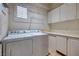 Functional laundry room equipped with washer, dryer, cabinets, and counter space at 472 Via Stretto Ave, Henderson, NV 89011
