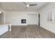 Living room with a fireplace and bright light coming through the large windows at 472 Via Stretto Ave, Henderson, NV 89011