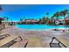 Zero entry community pool with palm trees and lounge chairs at 472 Via Stretto Ave, Henderson, NV 89011