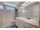 Bright bathroom featuring a vanity with a large mirror, bathtub, and tile flooring at 4773 Sarazen Cir, Las Vegas, NV 89103