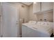 Functional laundry room with a washer, dryer, and storage cabinets for convenience at 4773 Sarazen Cir, Las Vegas, NV 89103