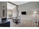 Open-concept living area showcasing modern flooring, a mounted TV, and seamless flow into the dining space at 4773 Sarazen Cir, Las Vegas, NV 89103