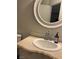 Bathroom vanity with round mirror and white sink at 520 Elm Dr # 202, Las Vegas, NV 89169