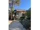 Two-story townhome with balconies and green awnings, with fenced yard at 520 Elm Dr # 202, Las Vegas, NV 89169