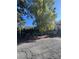 Street view showing mature trees and a fenced perimeter surrounding the multi-Gathering complex at 520 Elm Dr # 202, Las Vegas, NV 89169