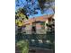 Two story townhouse with green awnings, gated seating area, and mature trees at 520 Elm Dr # 202, Las Vegas, NV 89169