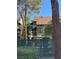 Exterior view of a multi-story building with green awnings and gated yards at 520 Elm Dr # 202, Las Vegas, NV 89169