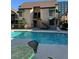Community pool with seating and nearby apartment buildings with balconies and awnings at 520 Elm Dr # 202, Las Vegas, NV 89169