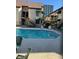 Sparkling community pool with lounge chairs, surrounded by apartment buildings with awnings at 520 Elm Dr # 202, Las Vegas, NV 89169