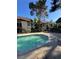Community pool surrounded by two-story apartment buildings with stairs and green awnings at 520 Elm Dr # 202, Las Vegas, NV 89169