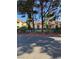 Multi-story apartment buildings with gated community pool surrounded by small yellow flowers at 520 Elm Dr # 202, Las Vegas, NV 89169