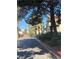 Exterior view of the community with mature trees, well maintained street, and palm trees at 520 Elm Dr # 202, Las Vegas, NV 89169