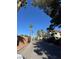 View down a street with palm trees, a brick wall, and multi-story apartments at 520 Elm Dr # 202, Las Vegas, NV 89169