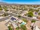 Expansive aerial view of a desert neighborhood featuring homes with pools and solar panels at 6301 Citrine Ave, Las Vegas, NV 89130