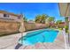 Private backyard with pool, artificial turf, and mature landscaping, ideal for relaxation at 6301 Citrine Ave, Las Vegas, NV 89130