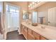 Bright bathroom features double sinks, wood cabinets, and shower-tub combo at 6301 Citrine Ave, Las Vegas, NV 89130