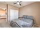 Well-lit bedroom featuring neutral tones, a ceiling fan, and ample closet space at 6301 Citrine Ave, Las Vegas, NV 89130