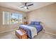 Comfortable bedroom featuring a ceiling fan, natural light, and neutral wall color at 6301 Citrine Ave, Las Vegas, NV 89130