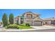 Attractive two-story home with desert landscaping, three-car garage, and a well-manicured lawn at 6301 Citrine Ave, Las Vegas, NV 89130