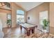Inviting game room featuring a pool table, large windows, and stylish flooring at 6301 Citrine Ave, Las Vegas, NV 89130