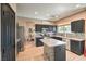 This modern kitchen includes stainless steel appliances, dark cabinetry, and an island at 6301 Citrine Ave, Las Vegas, NV 89130