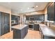 Enjoy this kitchen with stainless steel appliances, dark cabinetry, and an island at 6301 Citrine Ave, Las Vegas, NV 89130