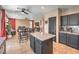 Beautiful open concept kitchen with dark cabinetry and flows into the living room at 6301 Citrine Ave, Las Vegas, NV 89130