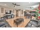 An open concept living room features a tile floor, ceiling fans, and open access to the kitchen at 6301 Citrine Ave, Las Vegas, NV 89130