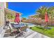 Inviting outdoor patio with barbecue, seating and view of the refreshing pool at 6301 Citrine Ave, Las Vegas, NV 89130