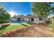Landscaped backyard features a pool, grass, an open area, and a low brick wall to separate the spaces at 6771 Shelter Ln, Las Vegas, NV 89103